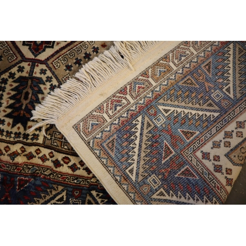 709 - Small middle eastern design cream and blue ground carpet, having geometric floral and foliate design... 