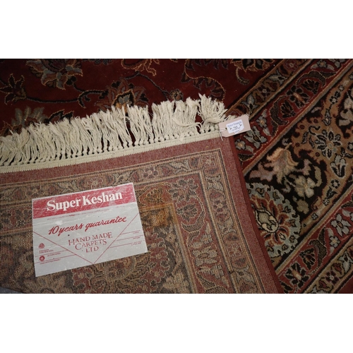 712 - Middle Eastern style red ground super Keshan carpet. 275 x 360cm approx. 
(B.P. 21% + VAT)