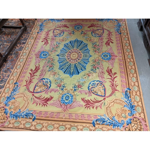 713 - Continental Aubusson style classically designed foliate and scroll decorated green ground carpet wit... 