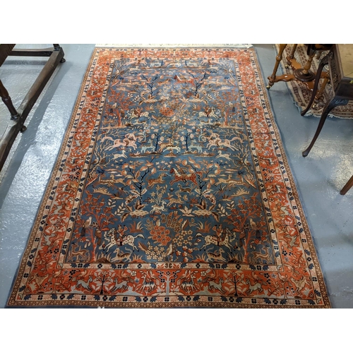 714 - Chinese Persian style blue ground rug, overall decorated with animals, birds and hunting scenes, wit... 