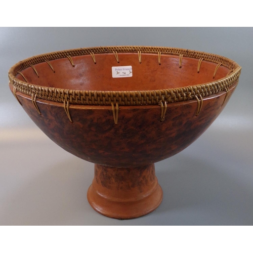 74 - Terracotta stemmed bowl with a basket weave to the rim, probably African origin.  30.5cm wide, 23cm ... 