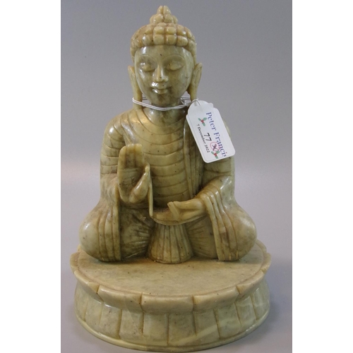 77 - A heavy green soapstone carved seated buddha on a lotus base.  
(B.P. 21% + VAT)