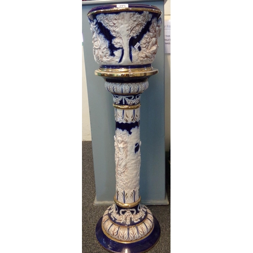 78A - Italian ceramic blue and white jardiniere on stand, overall with moulded decoration of mythical figu... 