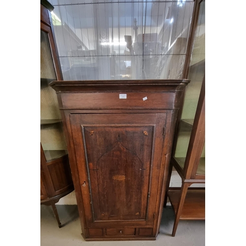 494 - Early 19th century oak single drawer blind panelled hanging corner cupboard, the interior revealing ... 