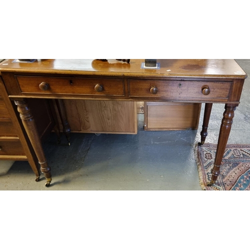 499 - Victorian mahogany two drawer desk/side table standing on baluster ring turned legs, cups and castor... 