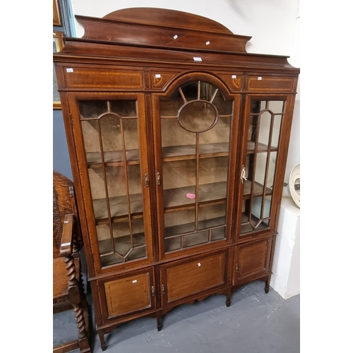 554 - Edwardian mahogany inlaid three door glazed display cabinet standing on tapering legs and spade feet... 