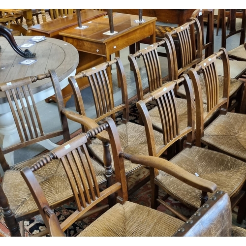 561 - Set of eight elm dining chairs, all having rush seats.  (6+2) (8)  (B.P. 21% + VAT)