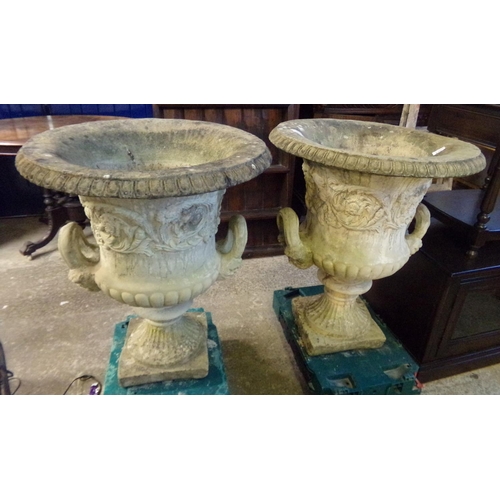 610 - Pair of weathered composition campana shaped two handled pedestal garden urns, on square bases.  80c... 