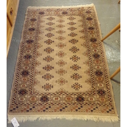 643 - Small beige ground middle eastern design runner, having central lozenge geometric decoration and flo... 