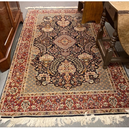 644 - Persian carpet on a multicoloured ground with central medallion, overall decorated with flowers and ... 