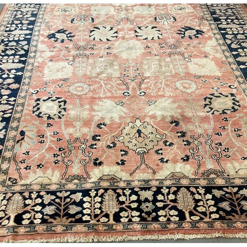 647 - Middle Eastern design blue and salmon ground carpet overall with stylised floral and foliate decorat... 