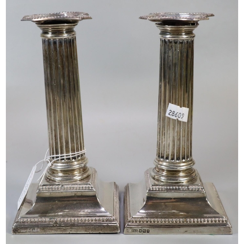 219 - Pair of early 20th century silver Corinthian Column candlesticks with loaded bases, makers mark 'T A... 