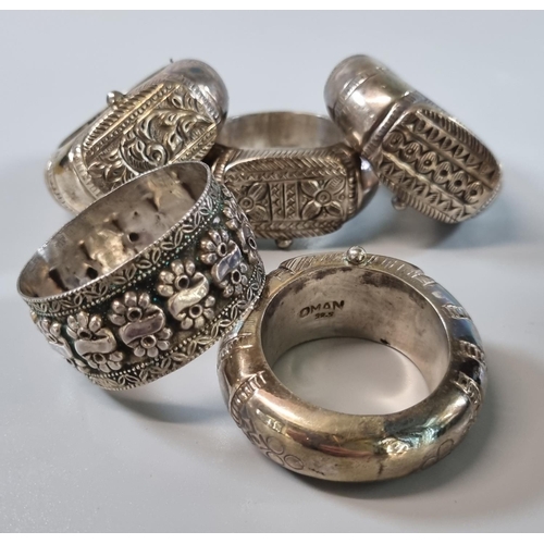 227 - Set of four silver napkin rings based on the traditional designs of bracelets and rings worn by Arab... 