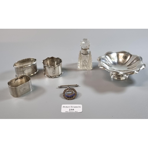 235 - Small silver bonbon dish together with three silver napkin rings, a silver topped and glass dressing... 