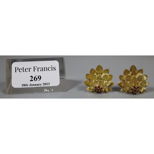 269 - A pair of 18ct gold clip earrings modelled as lotus flowers and stamped, 'Aly'.  Approx weight 10.5g... 