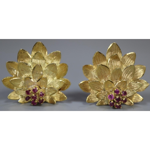 269 - A pair of 18ct gold clip earrings modelled as lotus flowers and stamped, 'Aly'.  Approx weight 10.5g... 