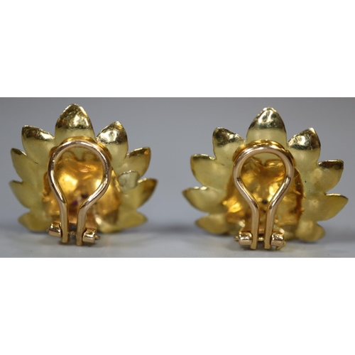 269 - A pair of 18ct gold clip earrings modelled as lotus flowers and stamped, 'Aly'.  Approx weight 10.5g... 