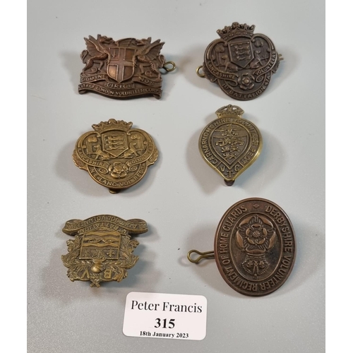 315 - Small collection of British Military Volunteer Battalion cap badges, including: Caernarvonshire Volu... 