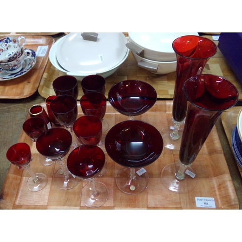 386 - Tray of cranberry glass items, mostly Czech drinking glasses with clear twisted stems; champagne, li... 