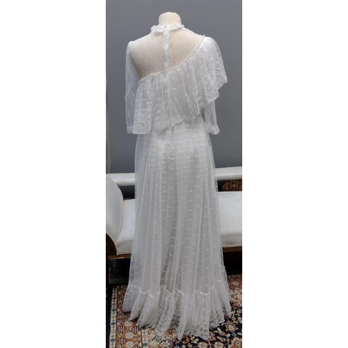 403 - Vintage 1970's lace wedding dress with tiered skirt, sheer sleeves and one shoulder ruffle. 
(B.P. 2... 