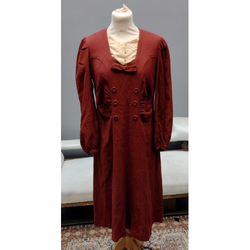 414 - Two vintage 1940's burgundy colour day dresses; one with bow and button detail down the front, the o... 