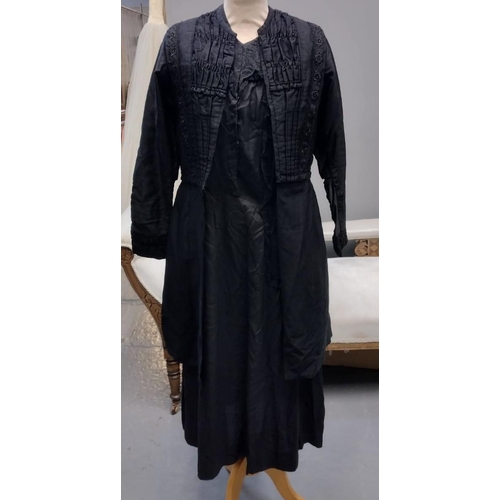 419 - Early 20th Century long sleeved black dress with brocade detail, together with a Victorian cotton ap... 