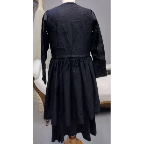 419 - Early 20th Century long sleeved black dress with brocade detail, together with a Victorian cotton ap... 