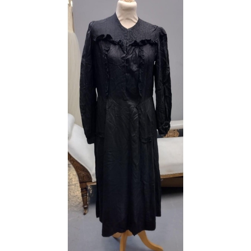 419 - Early 20th Century long sleeved black dress with brocade detail, together with a Victorian cotton ap... 