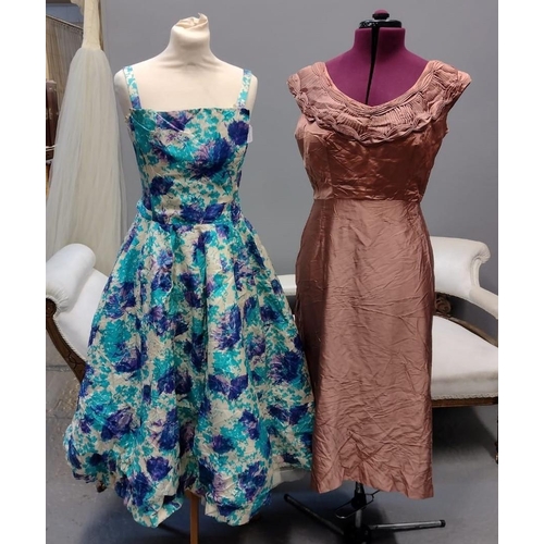 425 - Two 50's/60's vintage evening dresses; one is a floral printed ball gown type dress with built in un... 