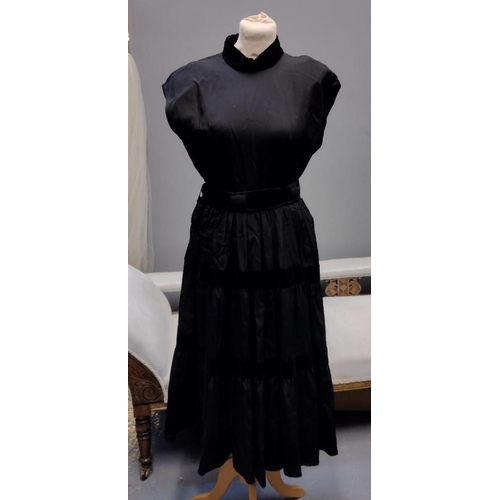 426 - Two 1950's/60's vintage black party dresses; one has pleated detail and the other has velvet stripes... 