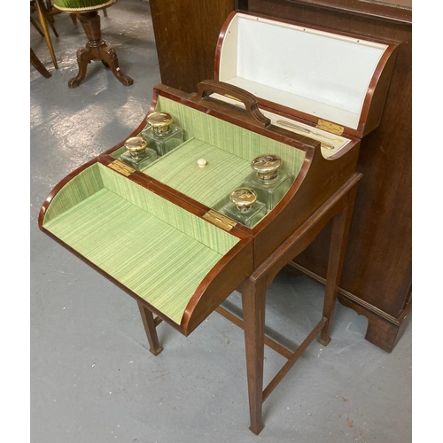 480 - Edwardian mahogany inlaid vanity set on stand, the interior revealing silver toped and glass dressin...