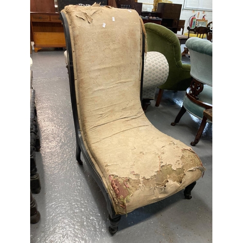 508 - 19th century ebonised and upholstered bedroom chair of low proportions on castors, in distressed con... 