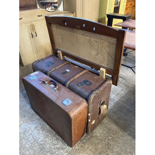 564 - Two vintage suitcases together with a pair of modern cane back single bed ends.  (4)  (B.P. 21% + VA... 