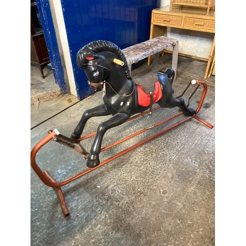 569 - Large plastic rocking horse on tubular metal swing frame.  (B.P. 21% + VAT)