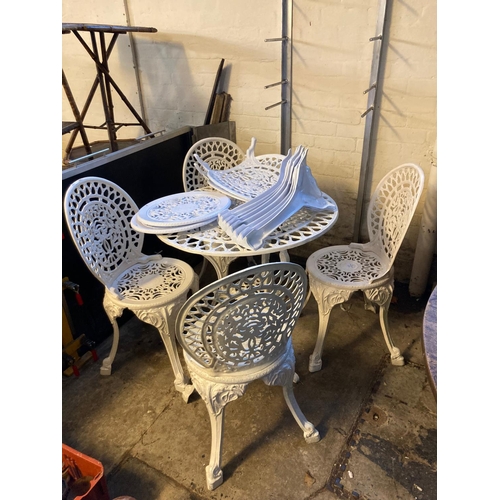 577 - Modern metal and pierced garden table of circular form with six matching garden chairs.  (B.P. 21% +... 