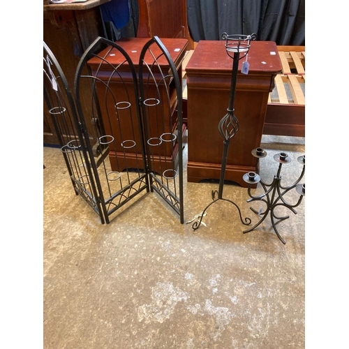 584 - Three metal furnishing items, to include: pierced three section screen, table candelabra and another... 