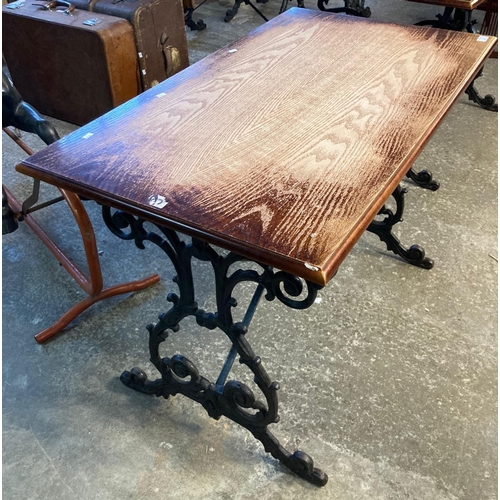 593 - Vintage oak top pub table with ornately scroll decorated cast iron base.   (B.P. 21% + VAT)