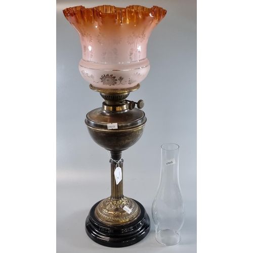 81 - Early 20th century double oil burner lamp having frosted orange etched floral shade with a brass res... 