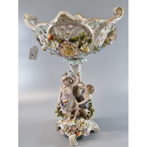 86 - Early 20th century German porcelain figural centre bowl decorated with encrusted flowers, foliage an... 