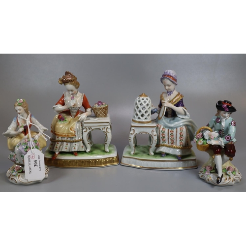 204 - Pair of continental porcelain figurines of a man and woman in 18th century dress with basket of flow... 