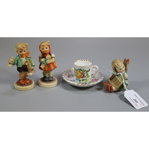 205 - Three Hummel figurines of children together with a miniature floral and gilded cup and saucer.   (B.... 