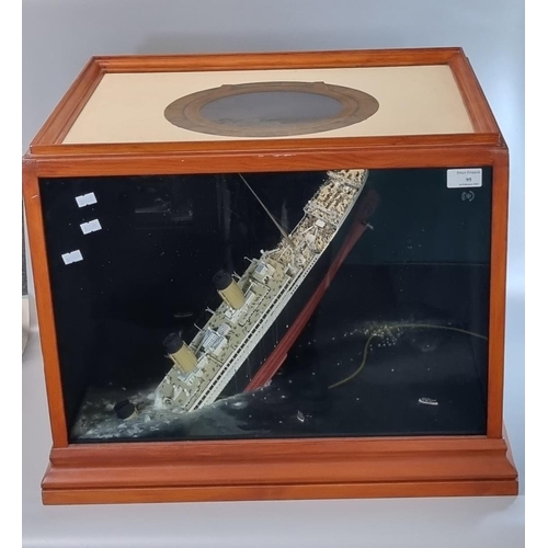 95 - Modern cased diorama of 'The sinking of the Titanic', the top with a painted porthole and the sides ... 