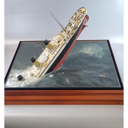 95 - Modern cased diorama of 'The sinking of the Titanic', the top with a painted porthole and the sides ... 