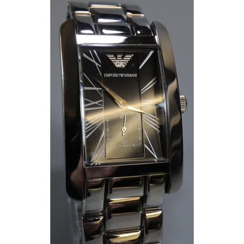 329 - An Emporio Armani gents steel rectangular faced wristwatch appearing in un-used condition, original ... 