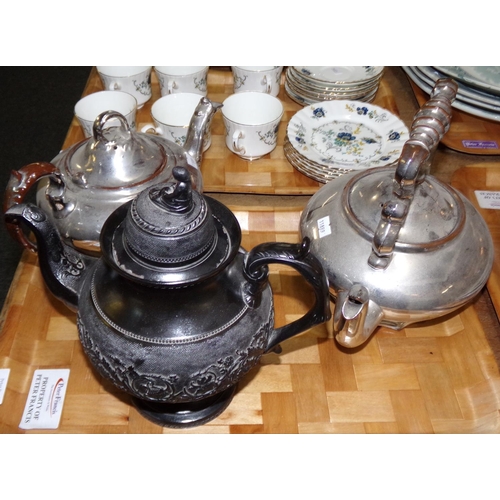 435 - Three teapots: one black basalt teapot with girl knop and pedestal base and two silvered ceramic tea... 