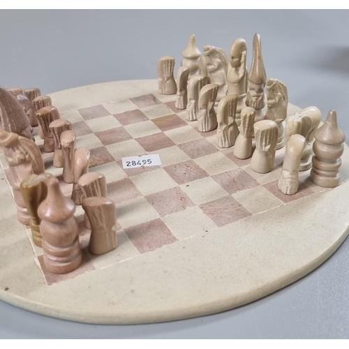 64 - Indian metal box comprising assorted chess pieces with a circular chess board. 
(B.P. 21% + VAT)