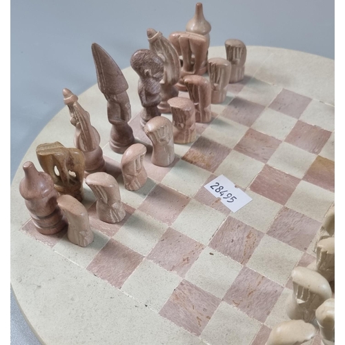 64 - Indian metal box comprising assorted chess pieces with a circular chess board. 
(B.P. 21% + VAT)