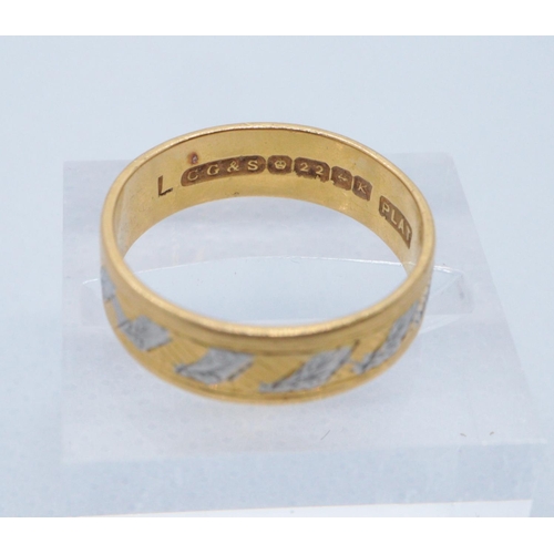 237 - 22ct gold bi-coloured engraved wedding ring. Size L + 1/2, 4.1g approx. 
(B.P. 21% + VAT)