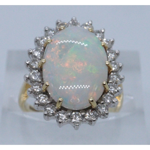 243 - 18ct gold opal and diamond dress ring. Size H + 1/2, 5.8g approx. Cased. 
(B.P. 21% + VAT)