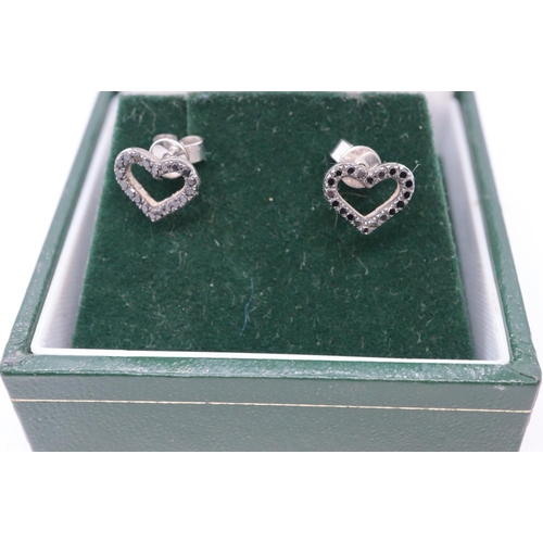 252 - Pair of 9ct white gold heart shaped earrings set with black diamonds. 1g approx. Cased.
(B.P. 21% + ... 